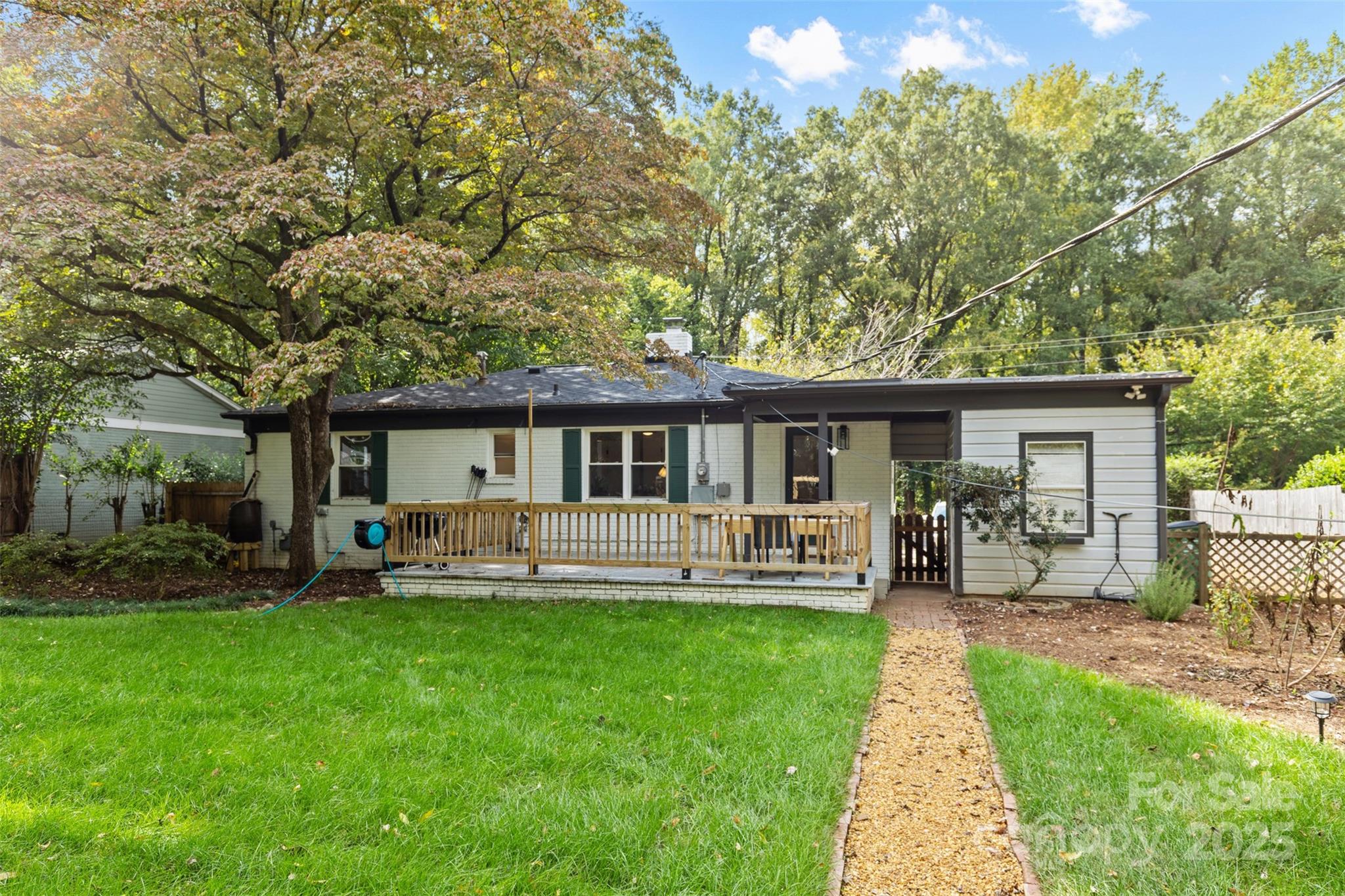 917 Scaleybark Road Charlotte, NC 28209 - Photo 34 of 42 a front view of house with a garden and patio