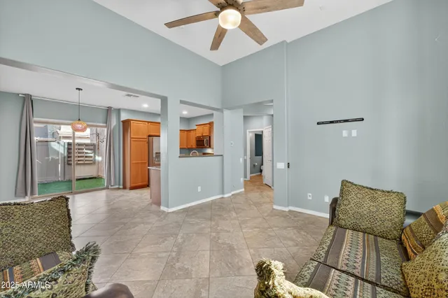a living room with furniture and a ceiling fan