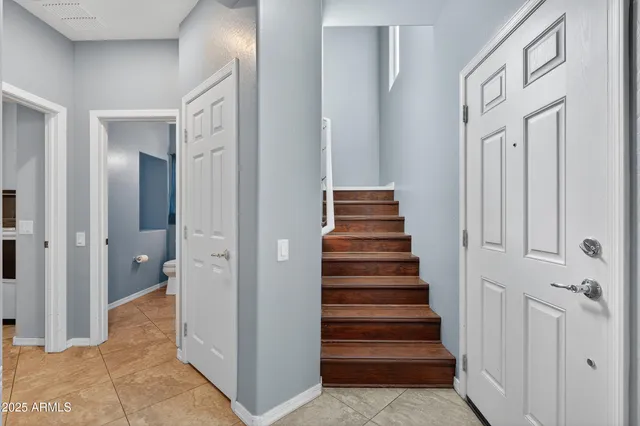 a view of a hallway with wooden shelves