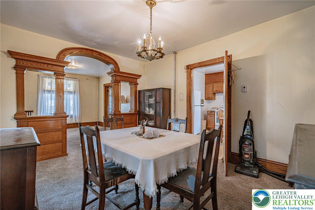 159 West Ridge Street Nesquehoning, PA 18240 - Photo 13 of 55 Ornate wood archways frame this generously proportioned dining space, ideal for formal meals.
