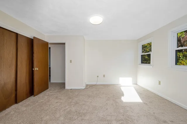 a view of an empty room with closet area