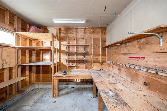 a view of a hallway to rooms with wooden floor