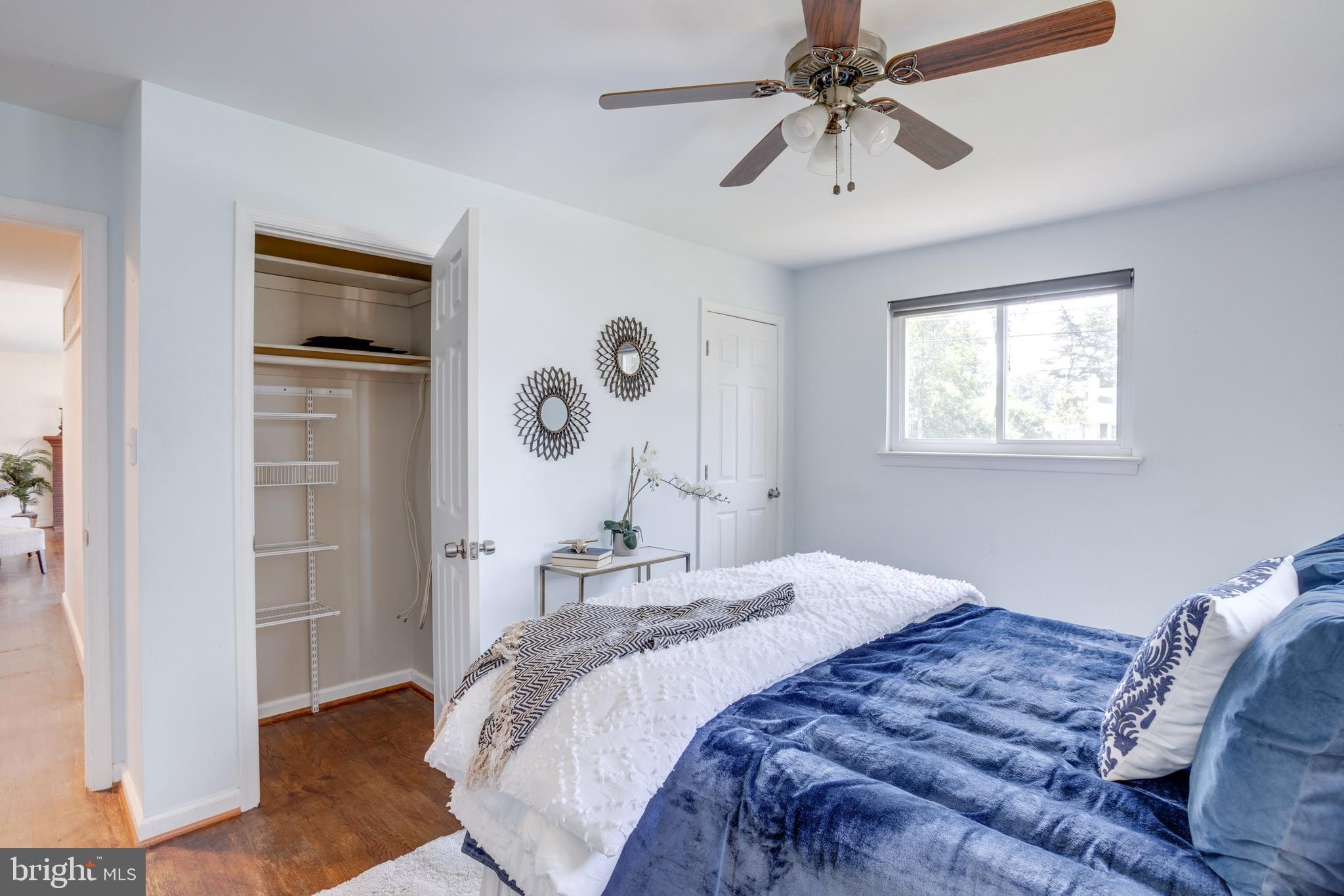 7424 Nancemond Street Springfield, VA 22150 - Photo 11 of 59 a bedroom with a bed and a chandelier