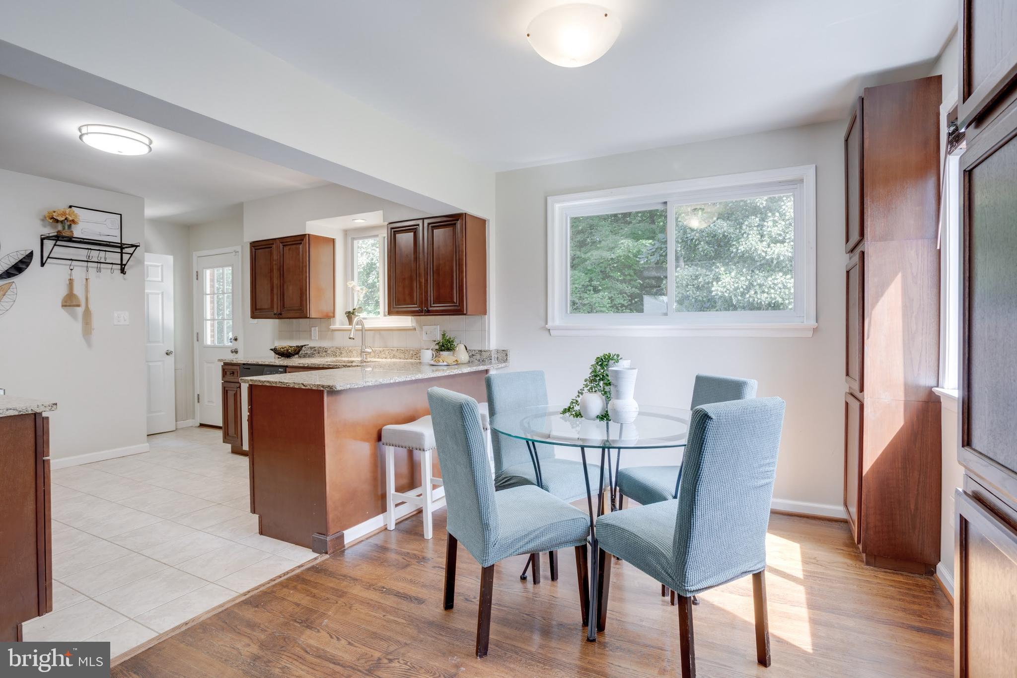 7424 Nancemond Street Springfield, VA 22150 - Photo 21 of 59 a view of a dining room with furniture window and wooden floor