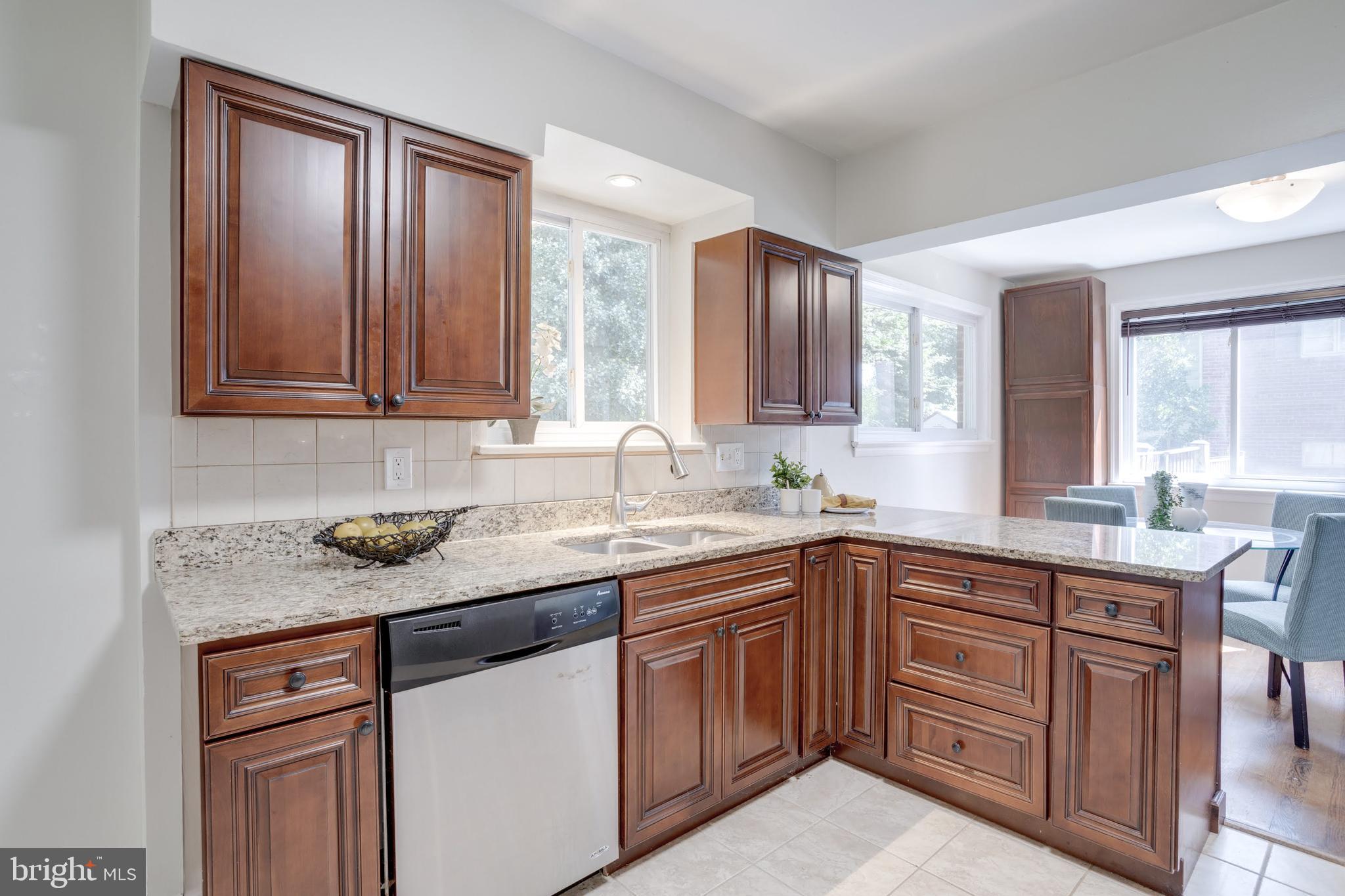 7424 Nancemond Street Springfield, VA 22150 - Photo 25 of 59 a kitchen with a sink stove and cabinets