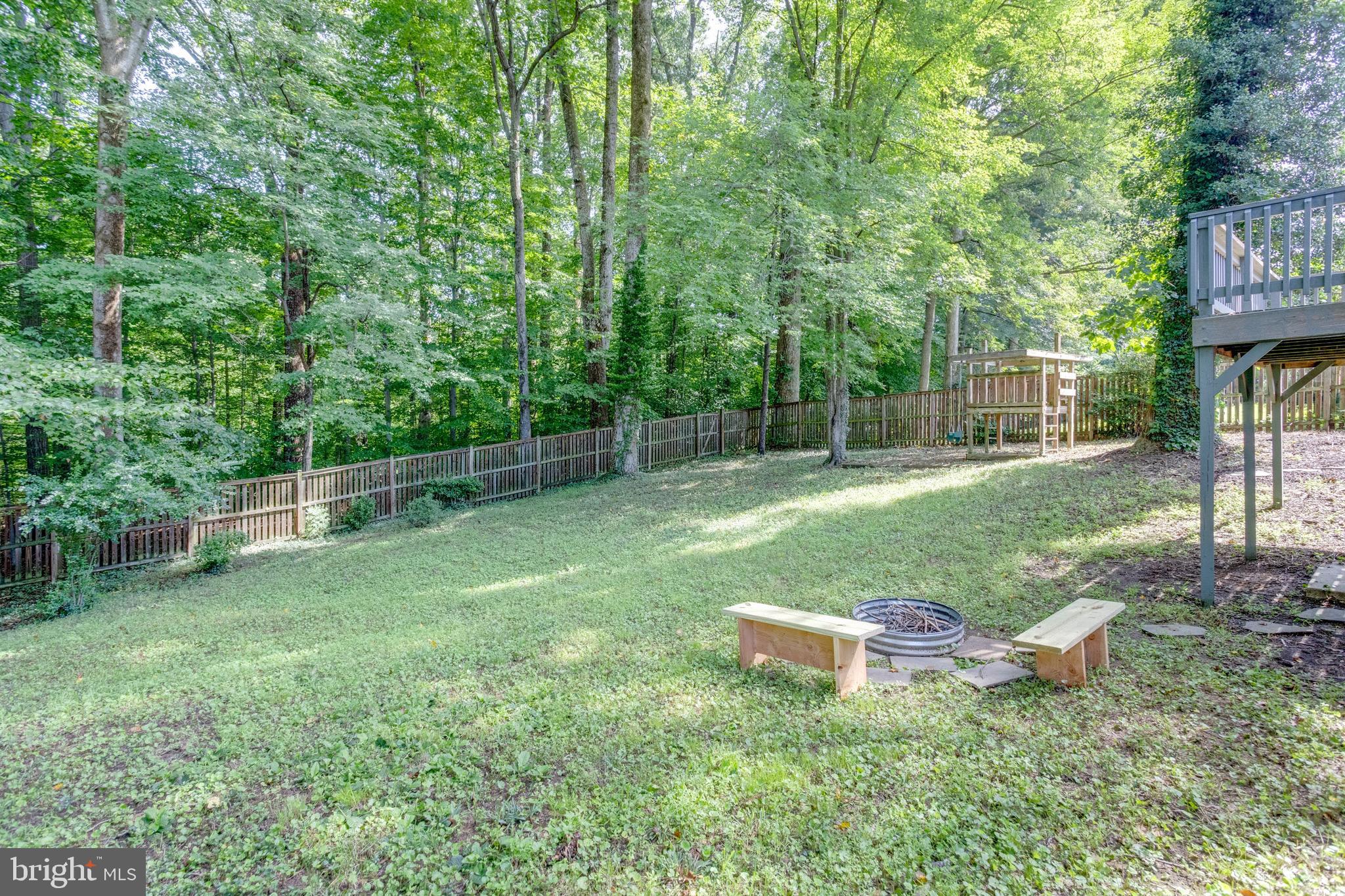7424 Nancemond Street Springfield, VA 22150 - Photo 42 of 59 a backyard of a house with seating and trees