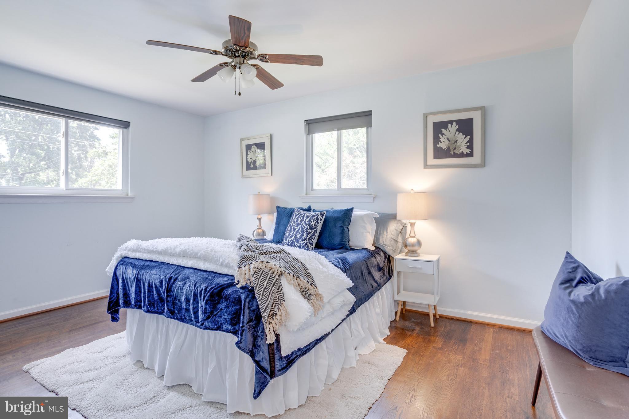 7424 Nancemond Street Springfield, VA 22150 - Photo 7 of 59 a bedroom with a bed and a chandelier
