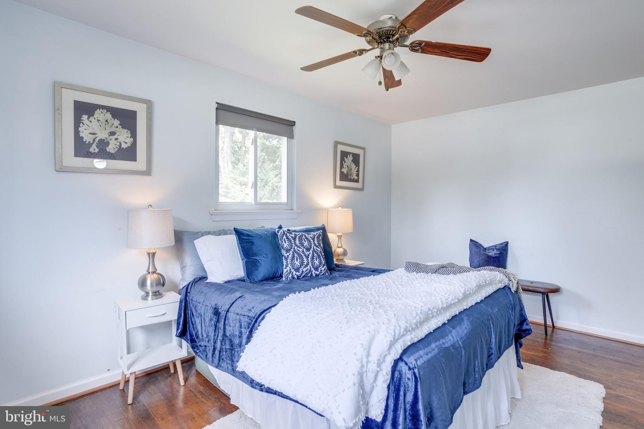 7424 Nancemond Street Springfield, VA 22150 - Photo 10 of 59 a bedroom with a bed and a chandelier
