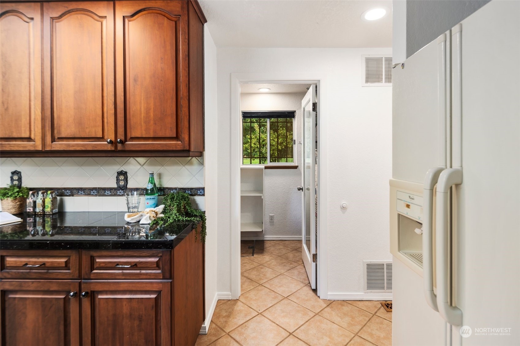 14844 Southeast 116th Street Renton, WA 98059 - Photo 11 of 38 a kitchen with stainless steel appliances granite countertop a refrigerator and a sink