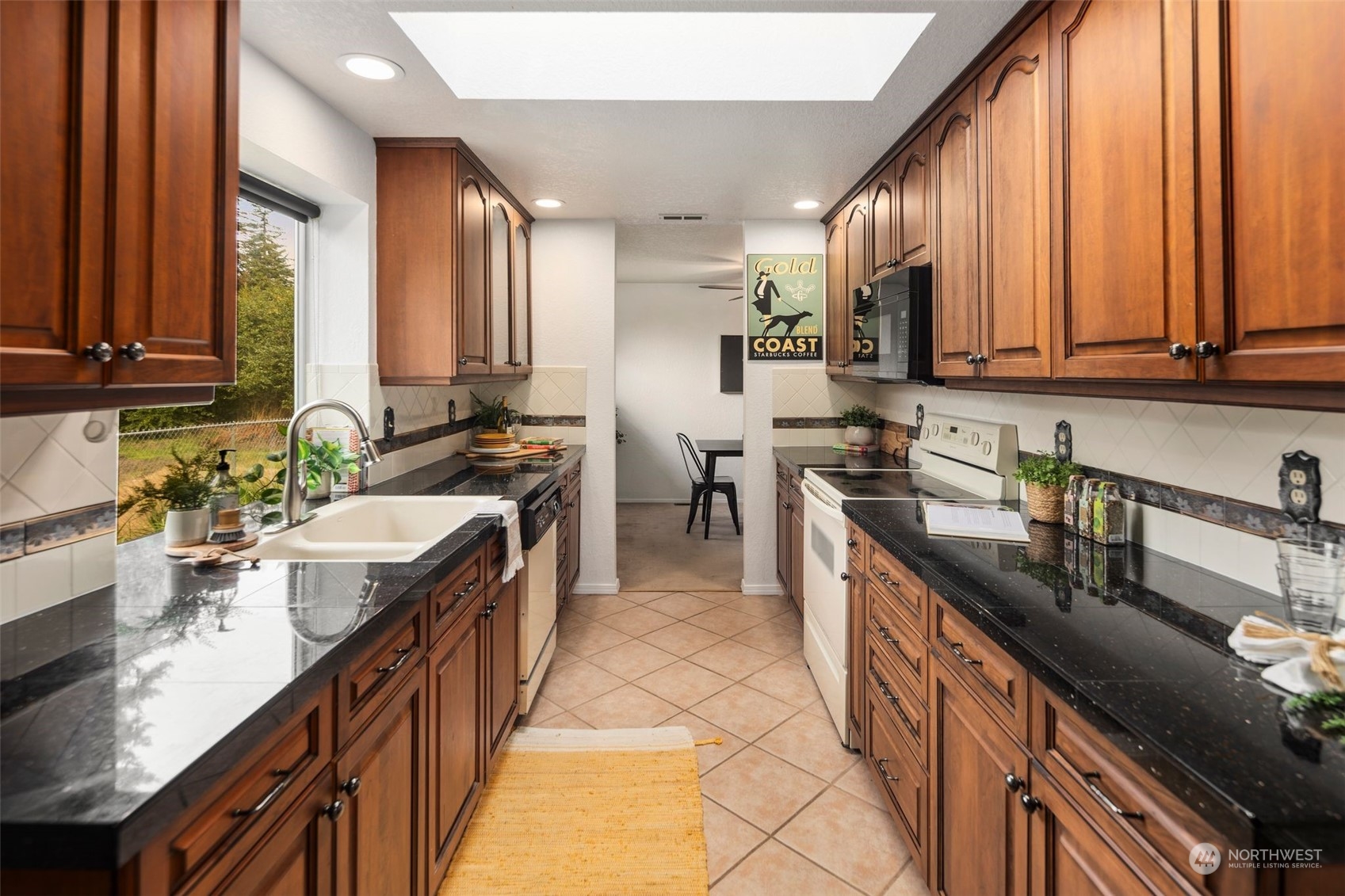 14844 Southeast 116th Street Renton, WA 98059 - Photo 12 of 38 a kitchen with kitchen island granite countertop a sink counter top space and stainless steel appliances