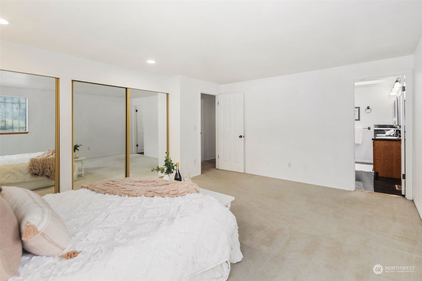 14844 Southeast 116th Street Renton, WA 98059 - Photo 17 of 38 a bedroom with a large bed and a chandelier