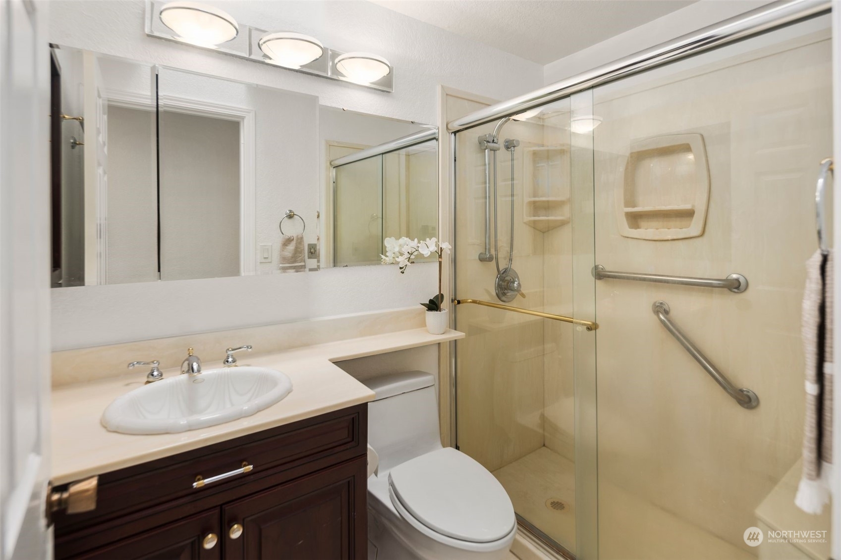14844 Southeast 116th Street Renton, WA 98059 - Photo 19 of 38 a bathroom with a sink toilet a mirror and shower