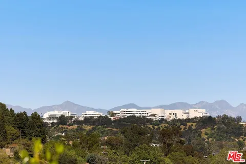 a view of a mountain range in a cloudy sky