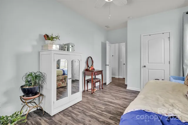 a bedroom with furniture and a wooden floor