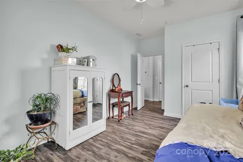 a bedroom with furniture and a wooden floor