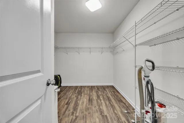 a bedroom with a bed and a flat tv screen on the dresser