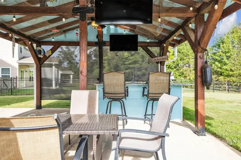 a view of an outdoor dining space with a table and chairs