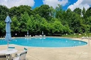 a view of a swimming pool with a yard