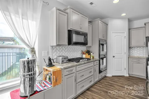 a kitchen with stainless steel appliances sink microwave and cabinets