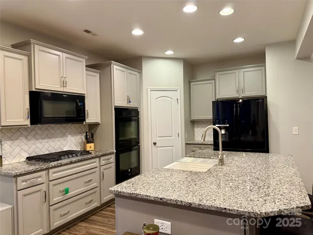 a kitchen with a sink microwave and refrigerator