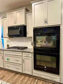 a stove top oven sitting inside of a kitchen