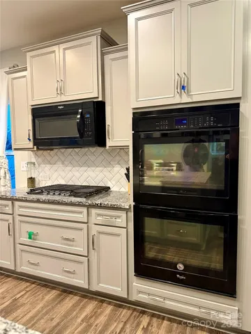 a stove top oven sitting inside of a kitchen