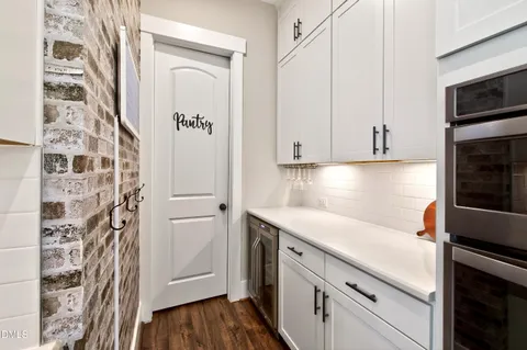 a large kitchen with lots of counter space and stainless steel appliances