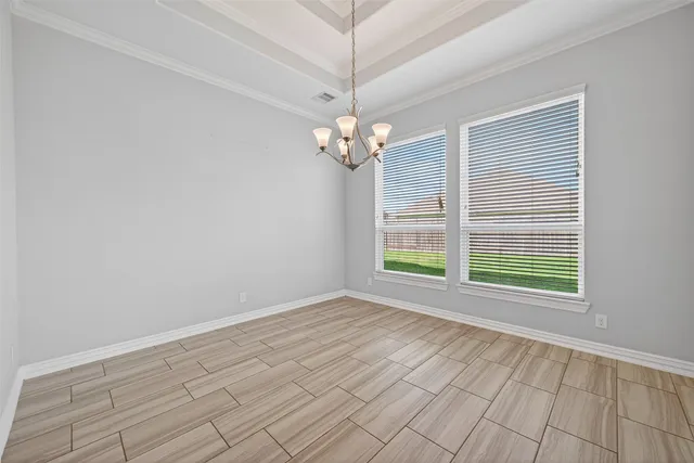 a view of kitchen with granite countertop cabinets and refrigerator