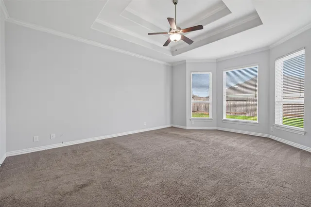 an empty room with closet and a ceiling fan