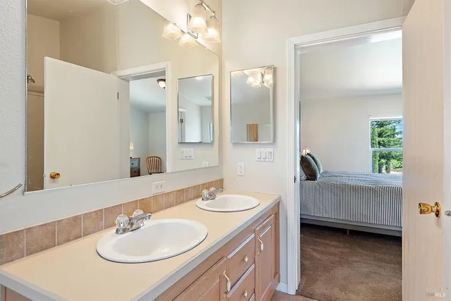 a bathroom with a sink double vanity and a mirror