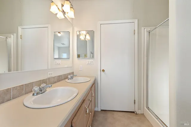 a spacious bathroom with a tub sink and mirror