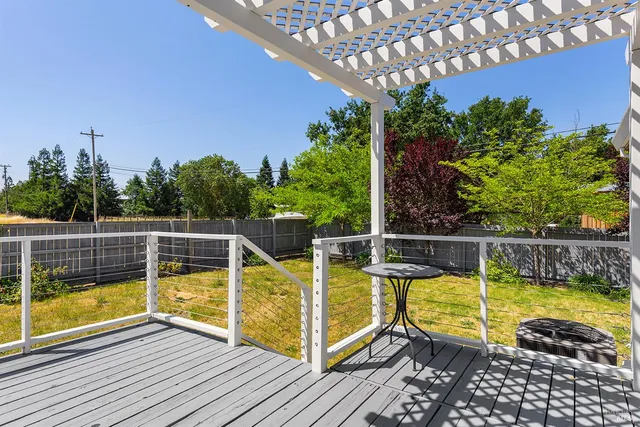 a view of a swimming pool with a patio and wooden floor