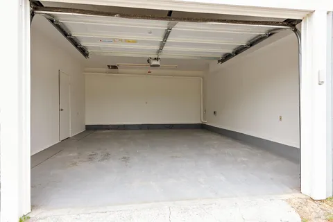 a view of an empty room with a fireplace and windows