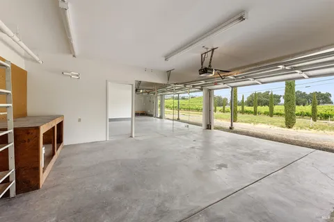 a view of a big house with a big yard and large trees