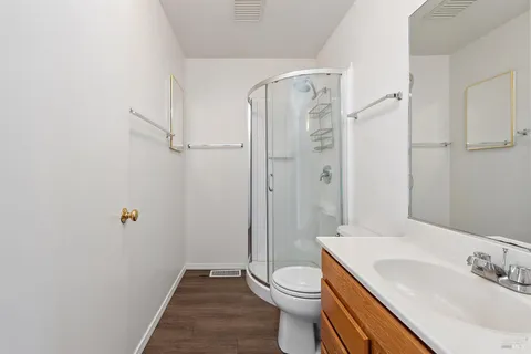 a view of a balcony with wooden floor & fence