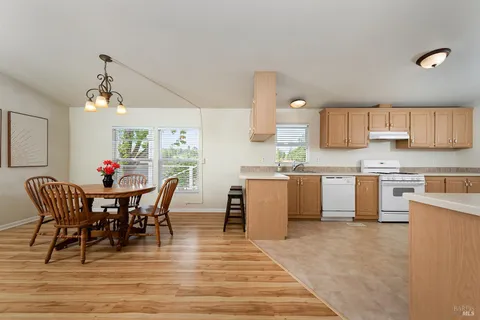 a view of kitchen with cabinets table and chairs