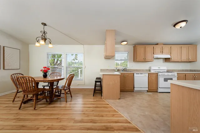 a view of kitchen with cabinets table and chairs