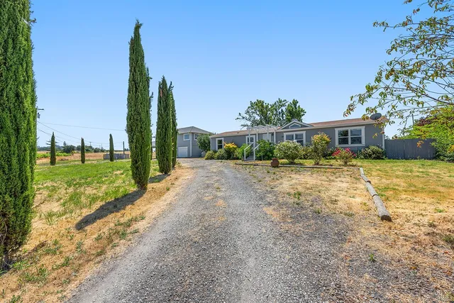 a view of a house with swimming pool and mountains in the background