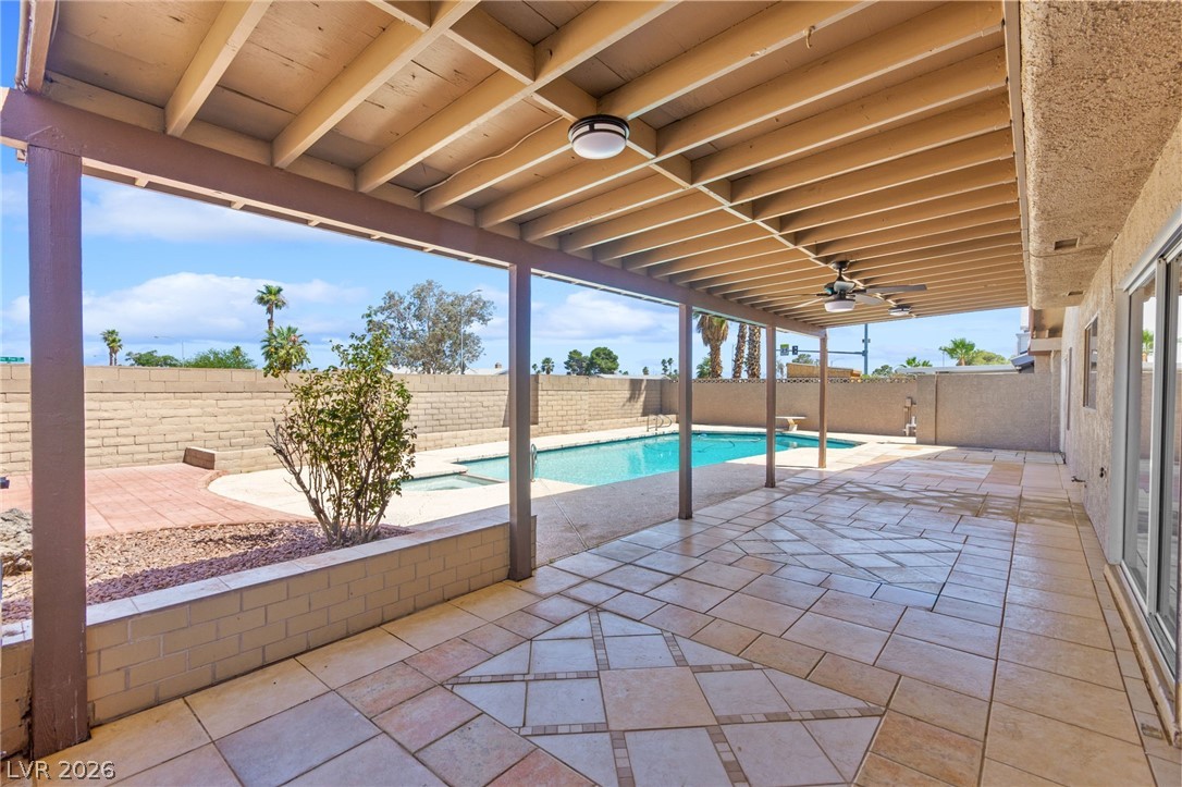 4430 Cranbrook Way Las Vegas, NV 89103 - Photo 22 of 50 A spacious covered patio overlooks a refreshing pool, creating an ideal outdoor living space.