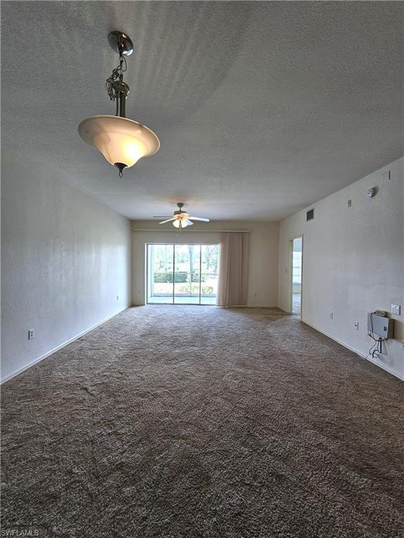 6025 Chardonnay Lane, Unit 102 Naples, FL 34119 - Photo 12 of 37 a view of empty room with a window and chandelier fan