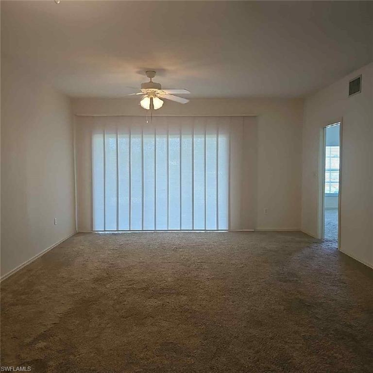 6025 Chardonnay Lane, Unit 102 Naples, FL 34119 - Photo 13 of 37 an empty room with fan and windows