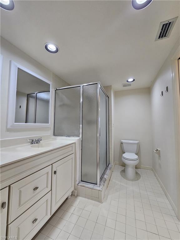 6025 Chardonnay Lane, Unit 102 Naples, FL 34119 - Photo 23 of 37 a bathroom with a toilet sink and a mirror