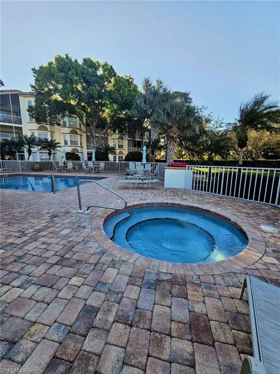 6025 Chardonnay Lane, Unit 102 Naples, FL 34119 - Photo 37 of 37 a swimming pool with outdoor seating and yard