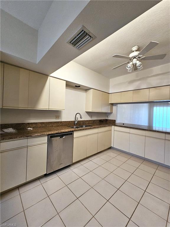 6025 Chardonnay Lane, Unit 102 Naples, FL 34119 - Photo 10 of 37 a kitchen with granite countertop a sink and cabinets