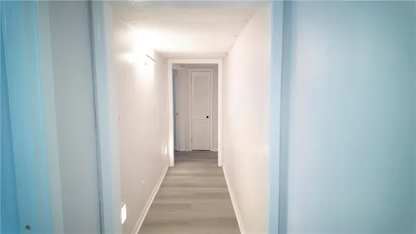 a view of a small space with wooden floor