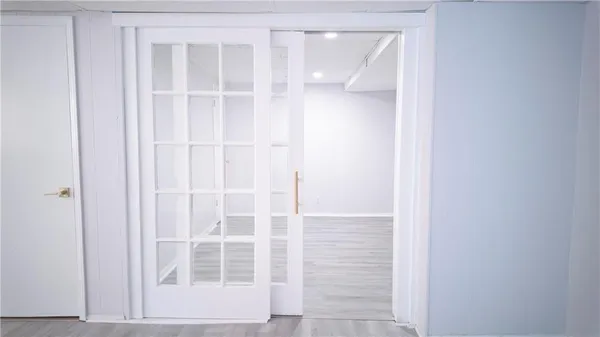 a view of a room with wooden floor