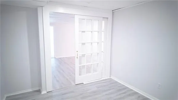 a view of an empty room with wooden floor