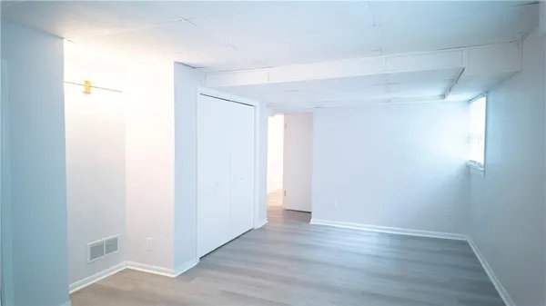 a kitchen with a white stove and white cabinets