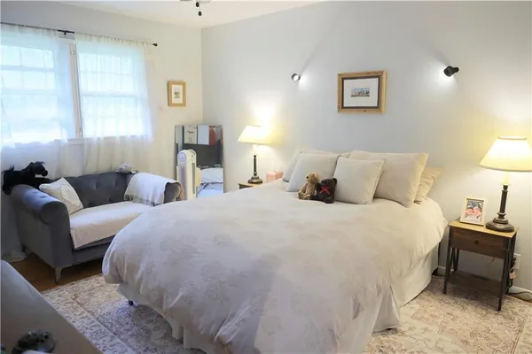a bedroom with a bed and painting on the wall