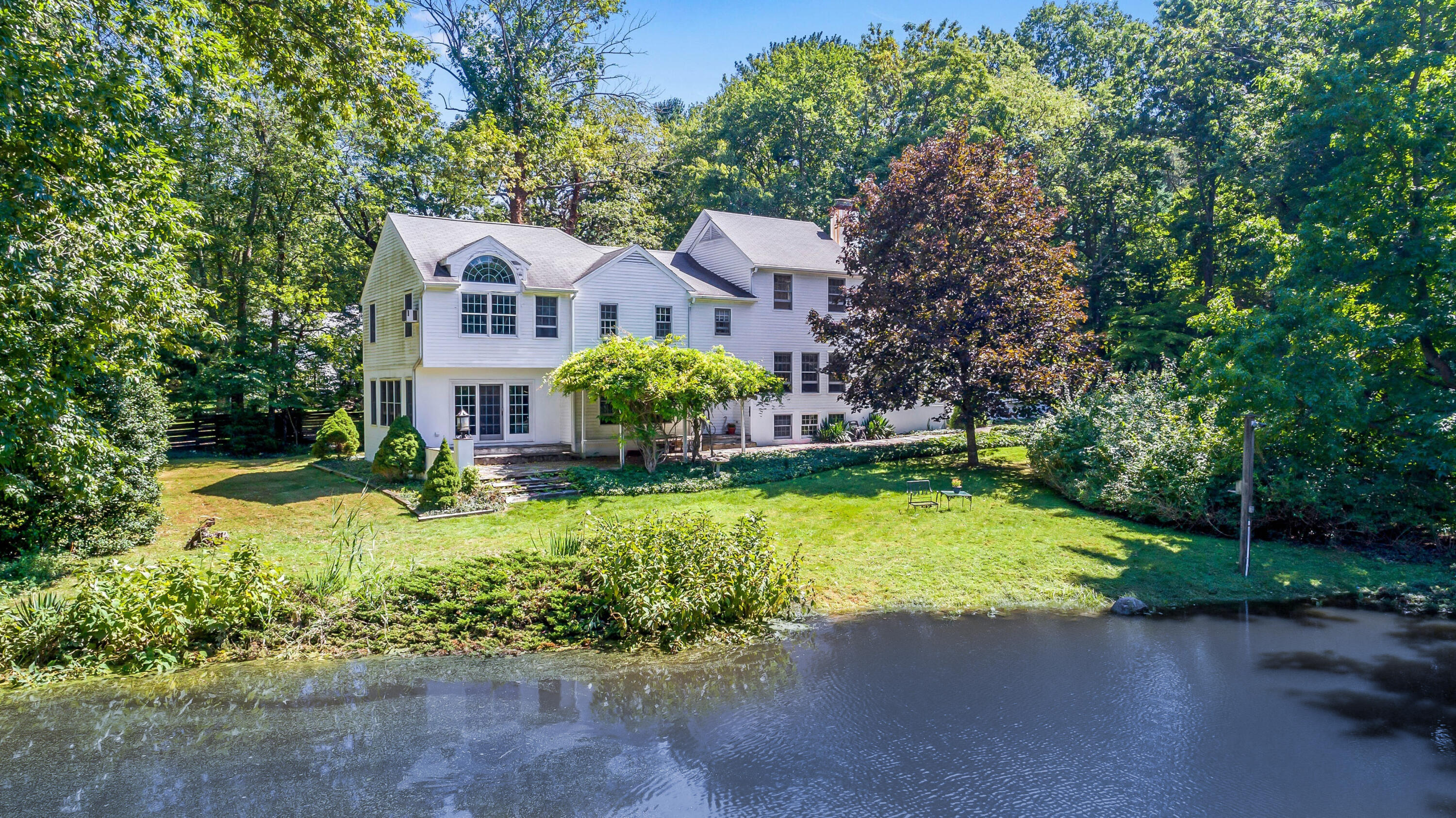 41 Old Farm Road Darien, CT 06820 - Photo 1 of 1 a front view of house with yard and green space